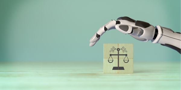 A robot hand hovers over a wooden block which has scales printed on the front. The background is shades of light green